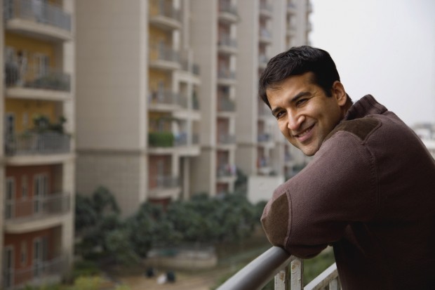 Man on Balcony of apartment