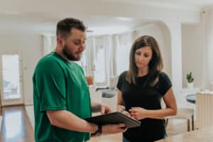 Mover discussing paperwork with a customer inside a home