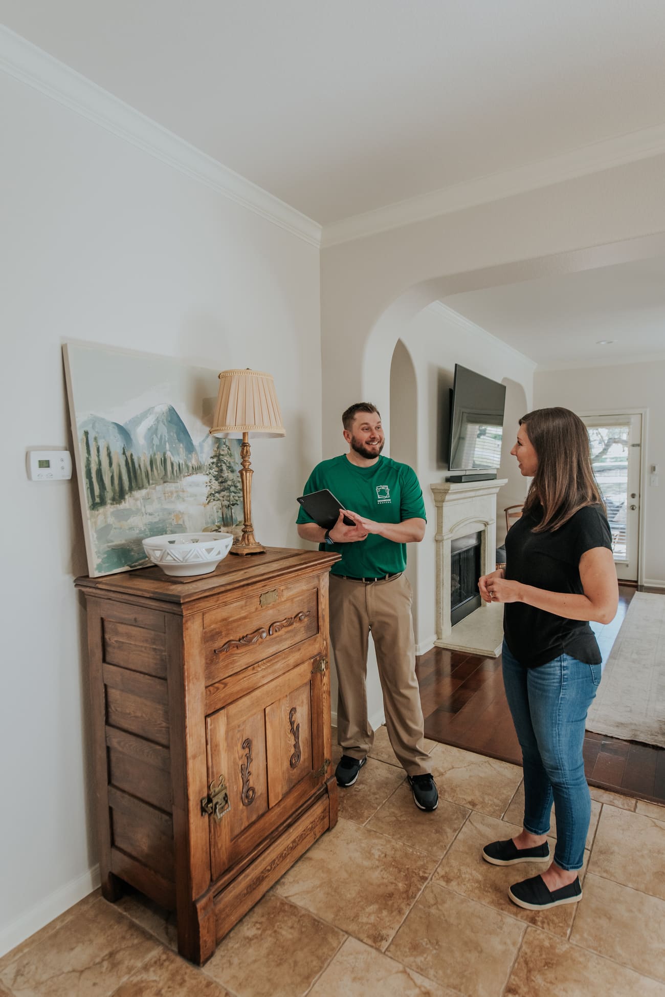 A man and woman stand together in a cozy living room