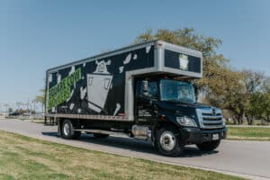 A Square Cow Movers truck drives down a street