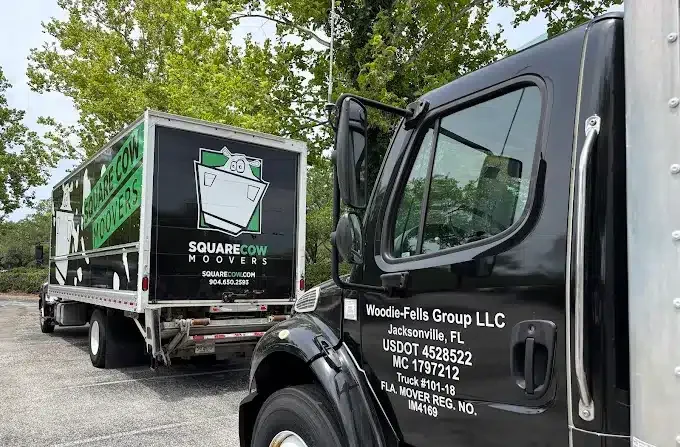 Picture of two Square Cow Movers Jacksonville Trucks
