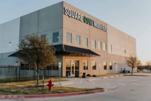 Square Cow Movers warehouse exterior with company sign