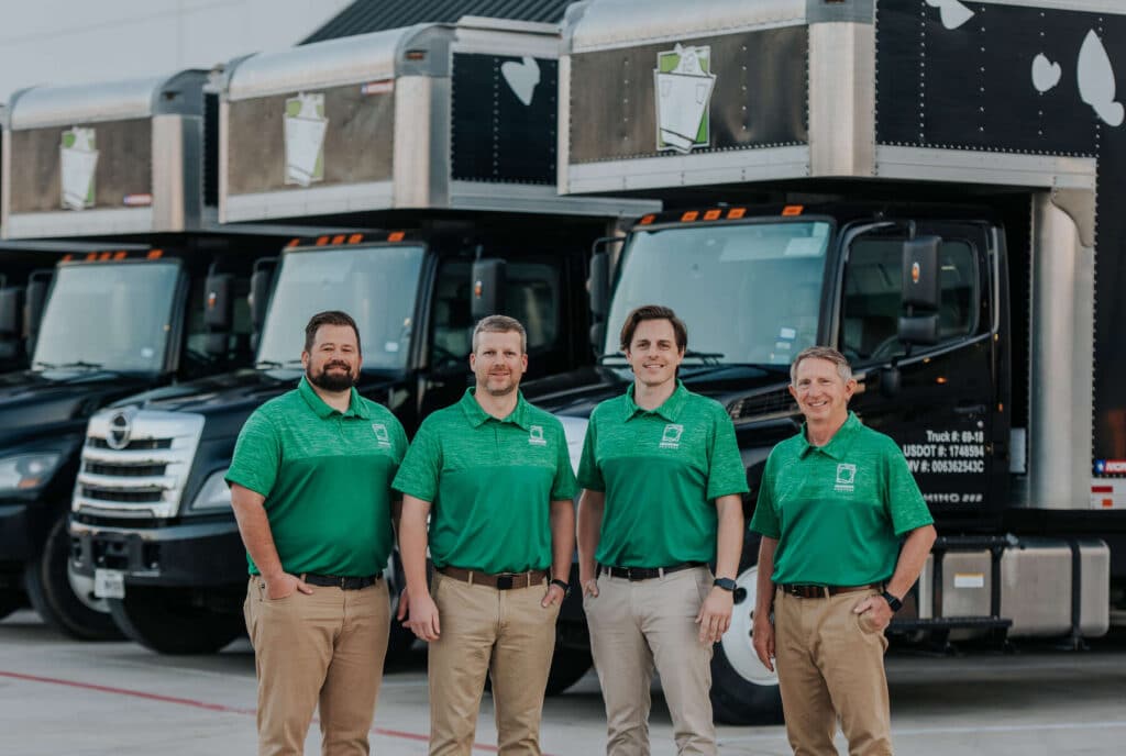 Moving company team standing in front of moving trucks