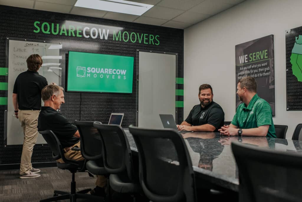 Square Cow Movers staff meeting in office conference room
