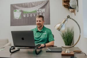 Square Cow Movers employee working at a desk with laptop