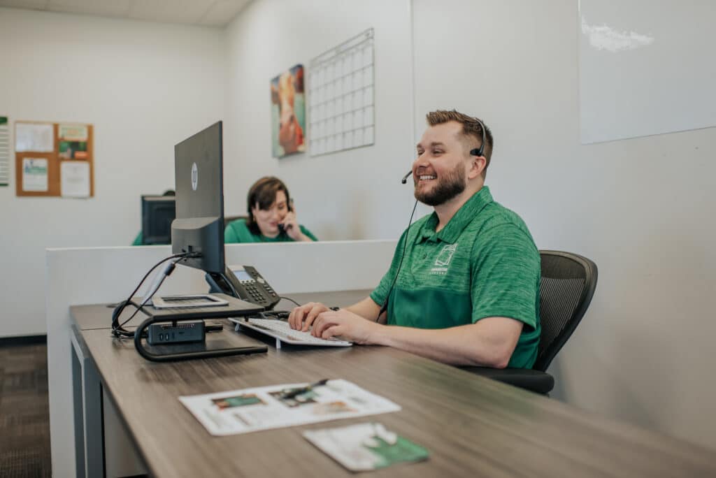 Customer service team member wearing a headset at Square Cow Movers office