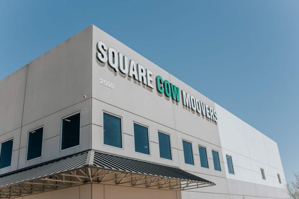 Square Cow Movers building exterior sign against blue sky