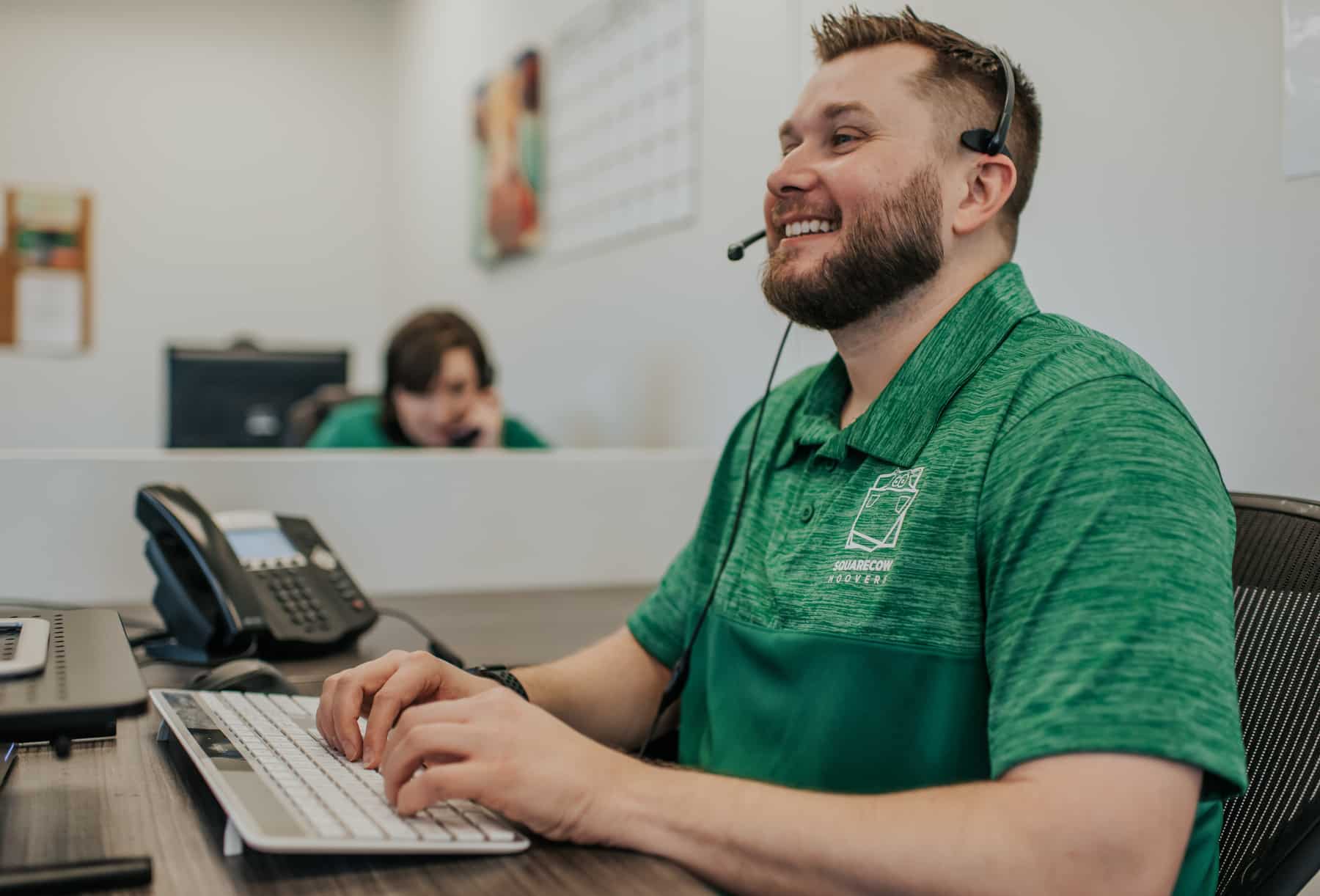 Square Cow Movers employee wearing a headset at a desk