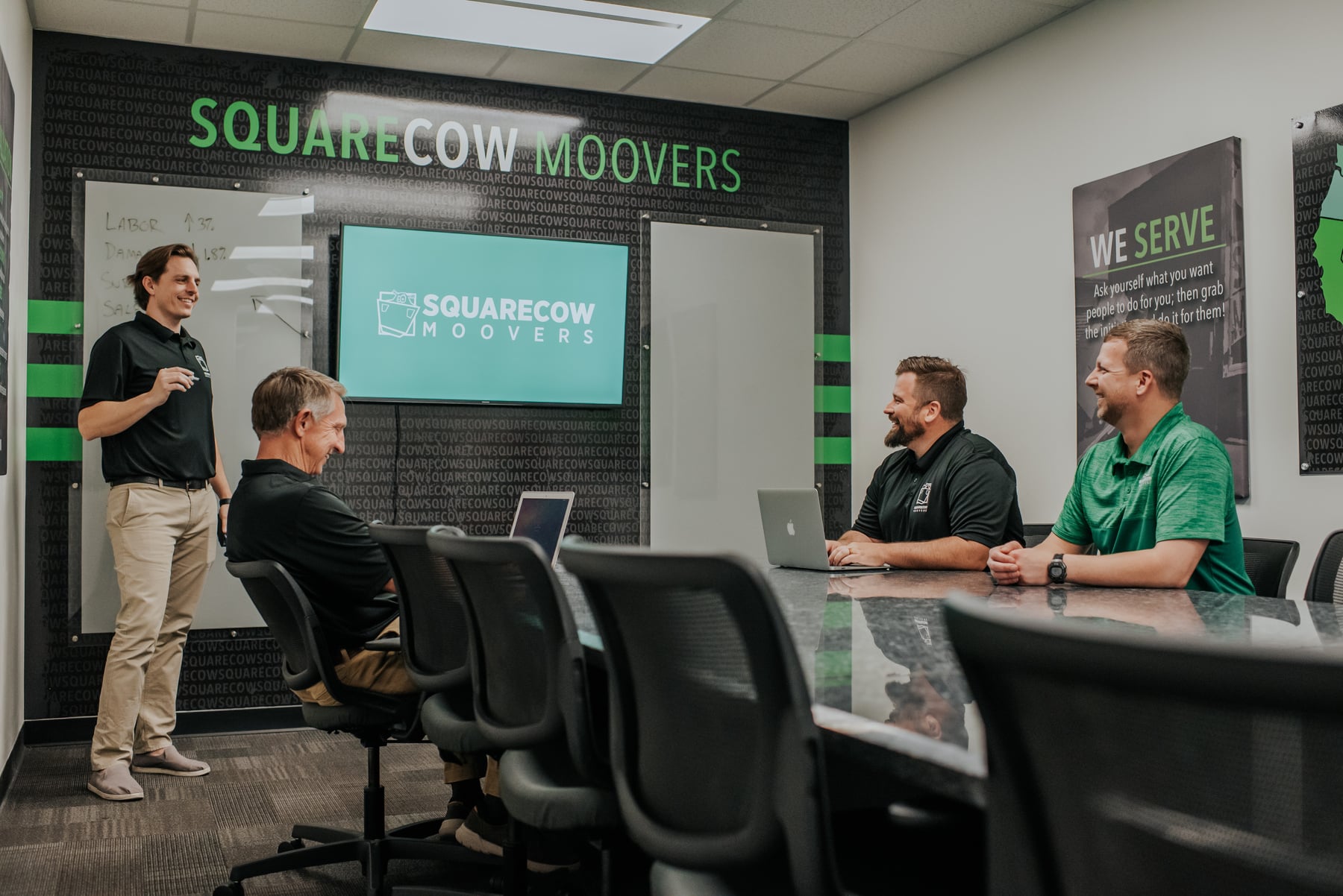 Team members in a Square Cow Movers conference room