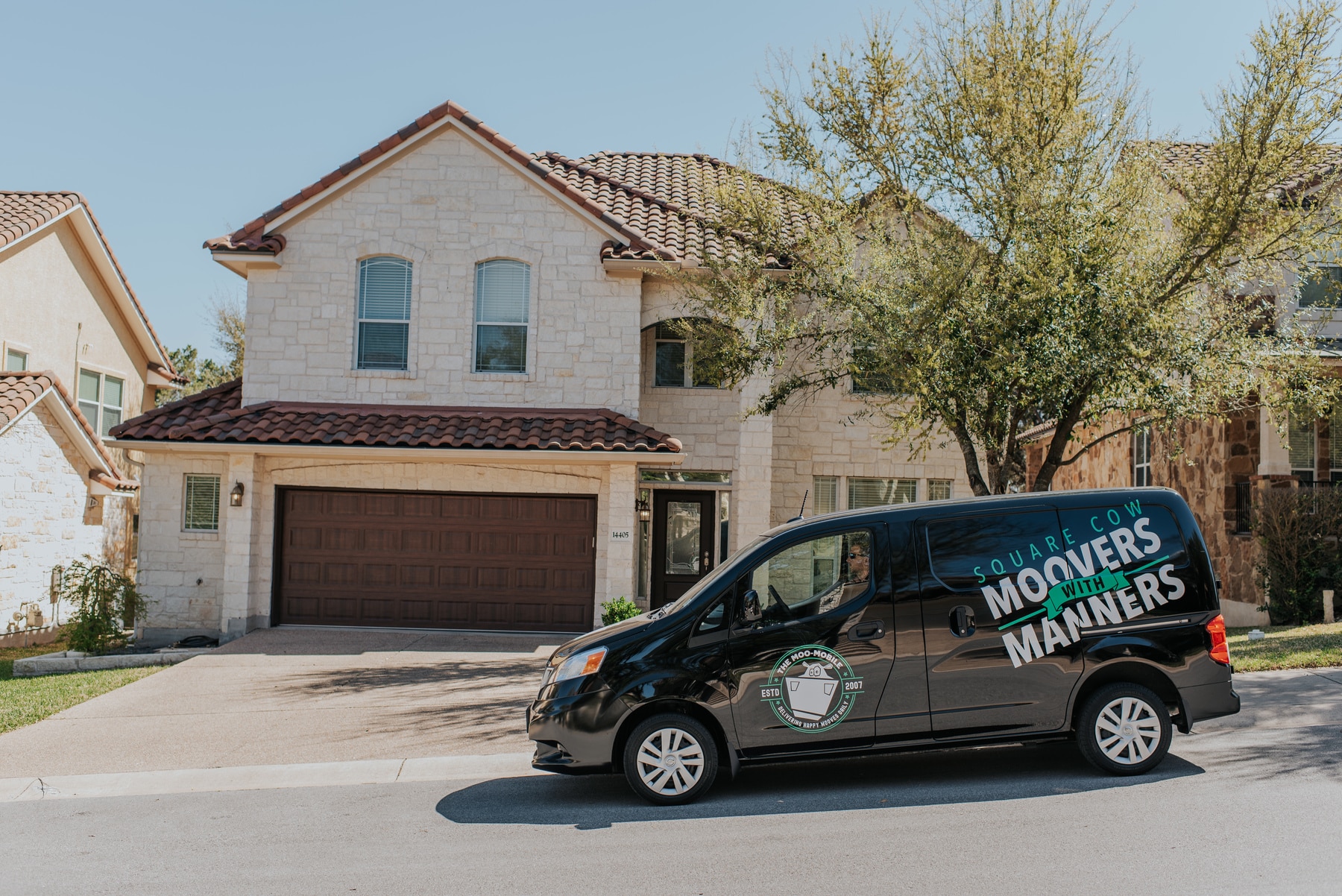 Square Cow Movers van parked outside a home