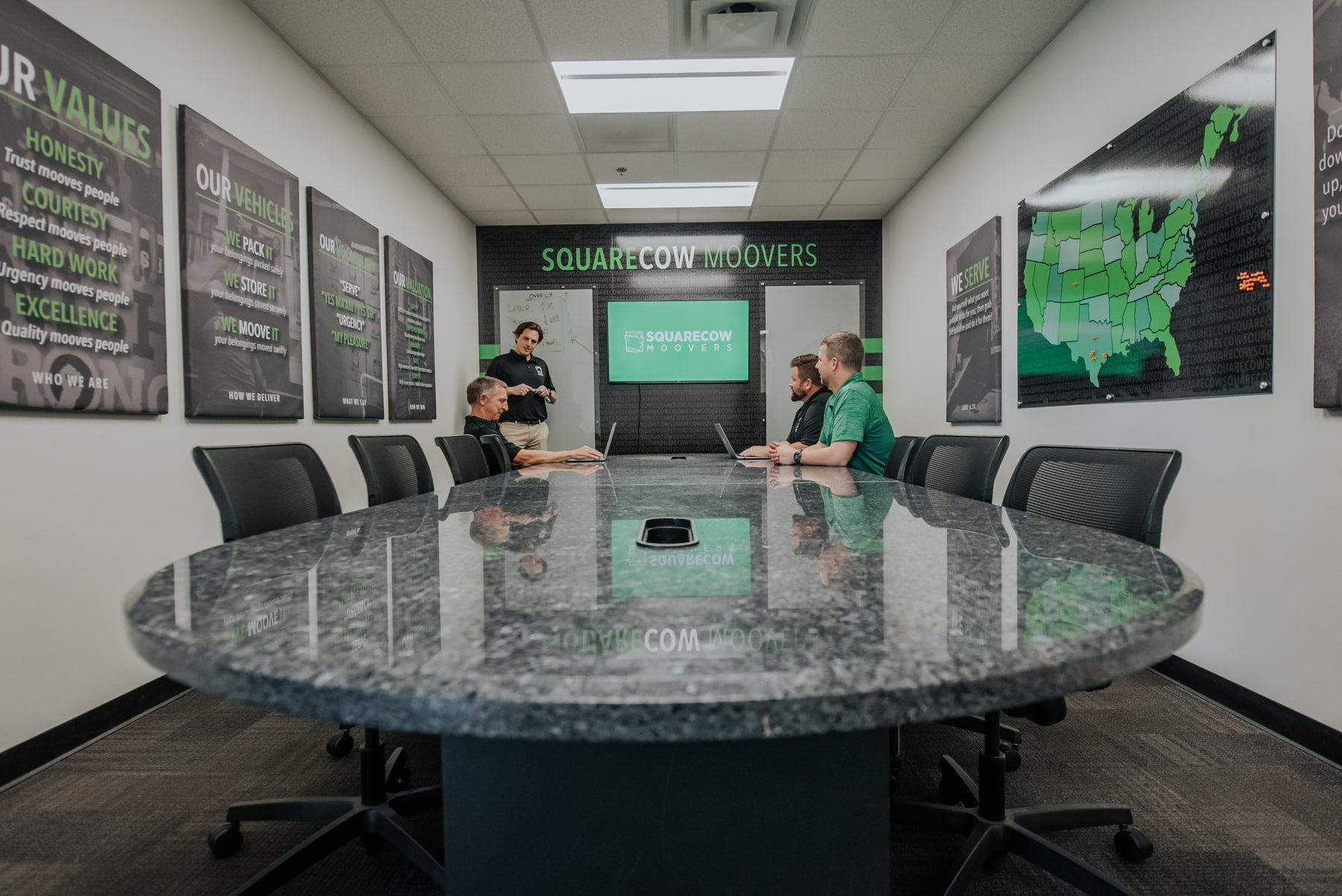 Square Cow Movers team meeting in a conference room