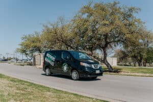 Square Cow Movers van driving on a neighborhood road