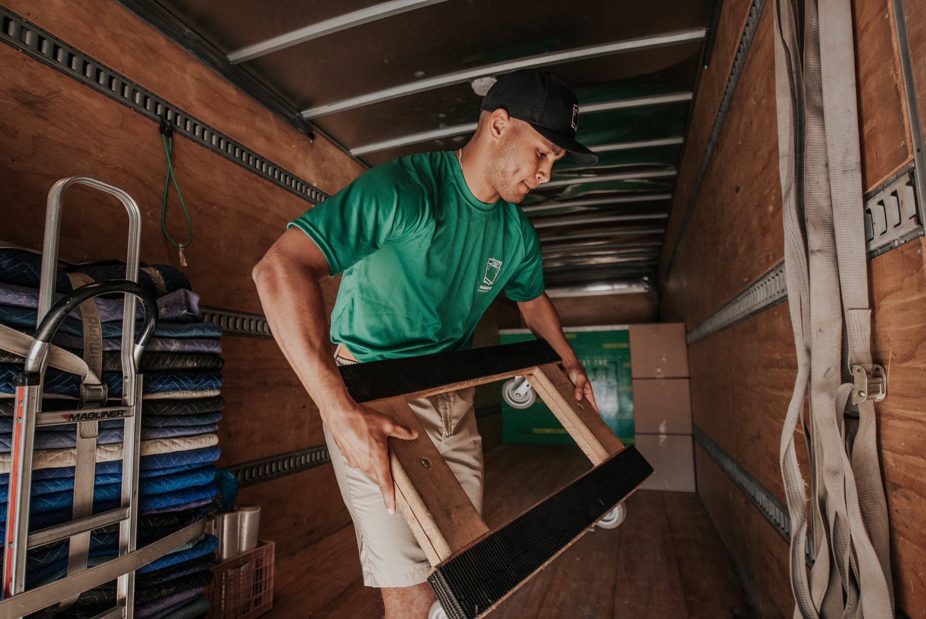 Square Cow Movers employee loading equipment into a truck