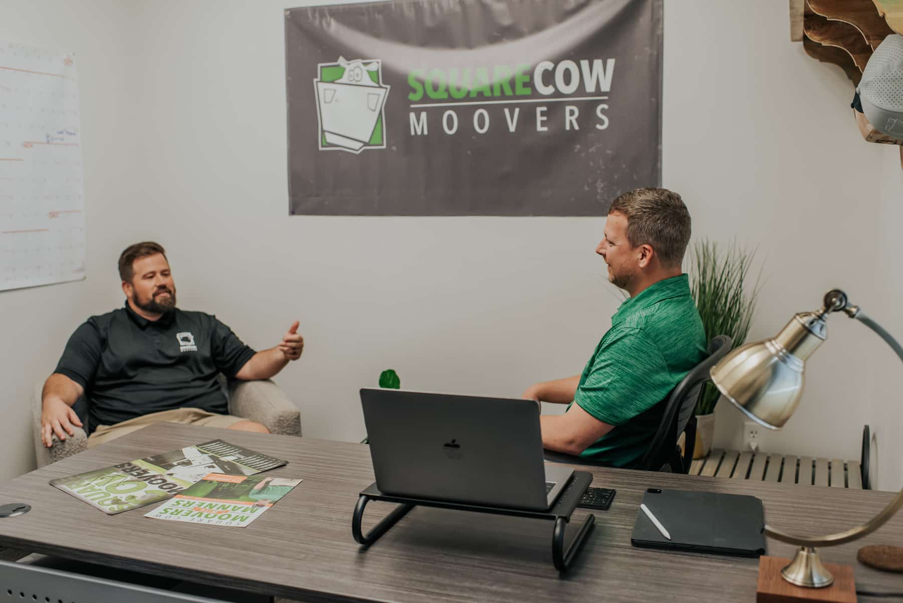 Square Cow Movers employees meeting in an office