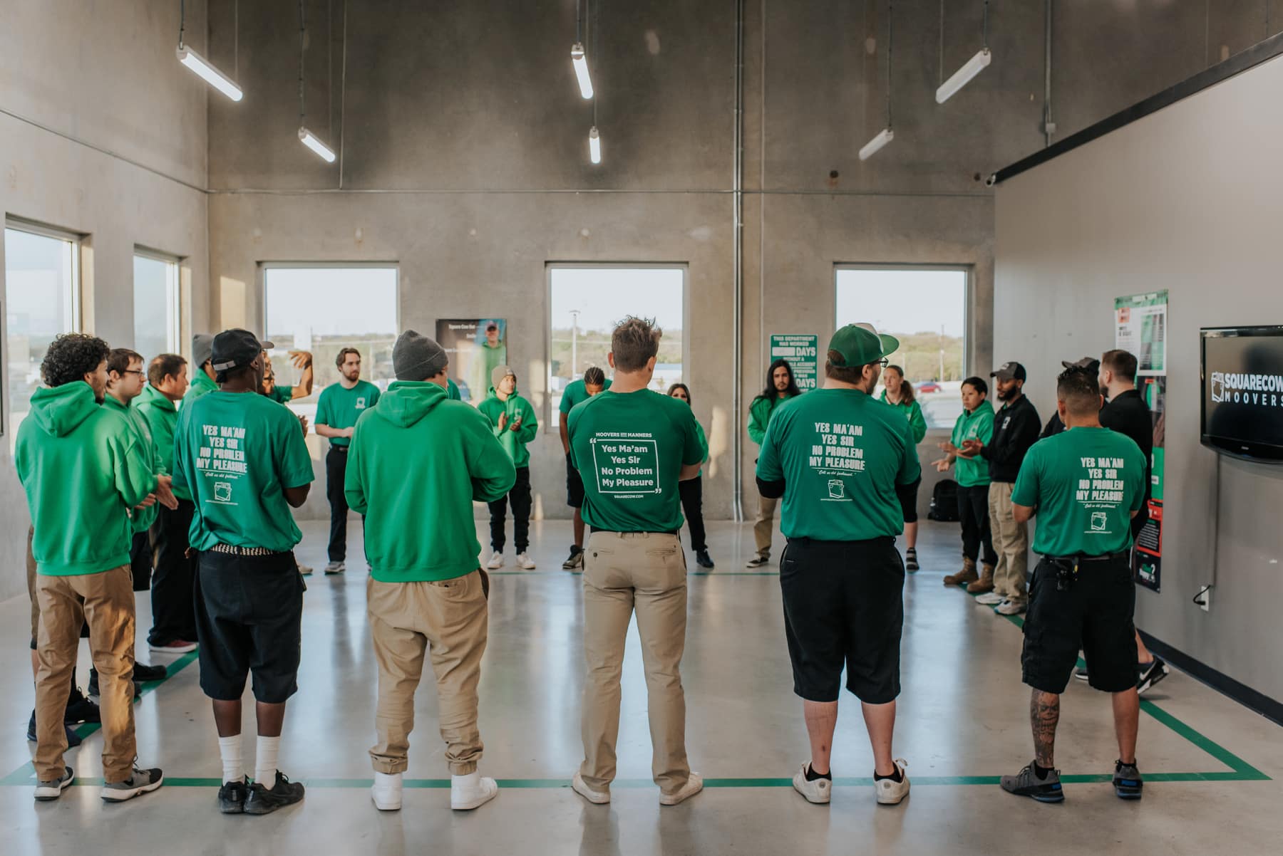 Square Cow Movers employees gathered for a team meeting