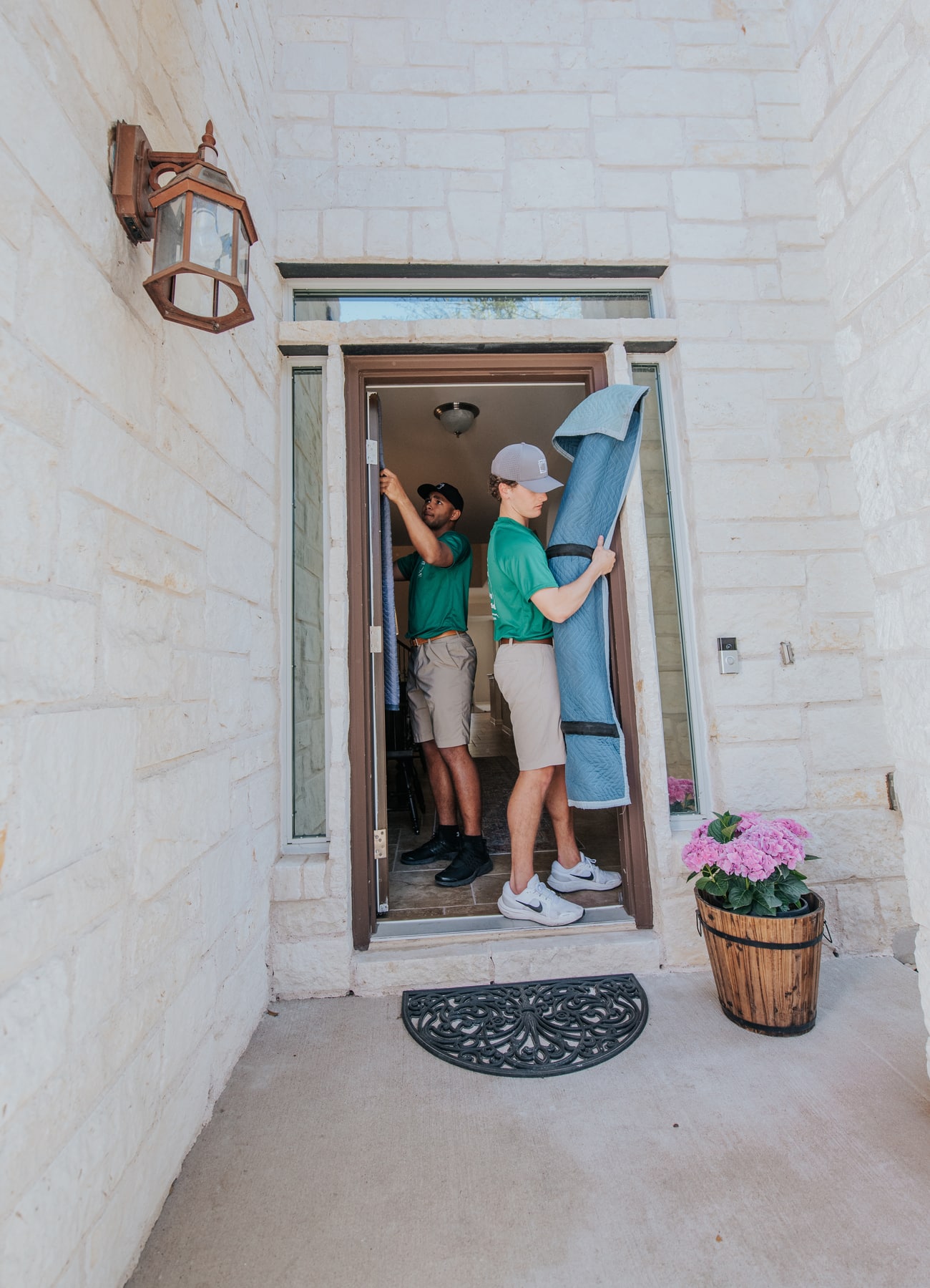 Square Cow Movers employees carrying a wrapped item through a doorway