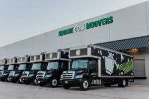 Square Cow Movers trucks parked outside the company building