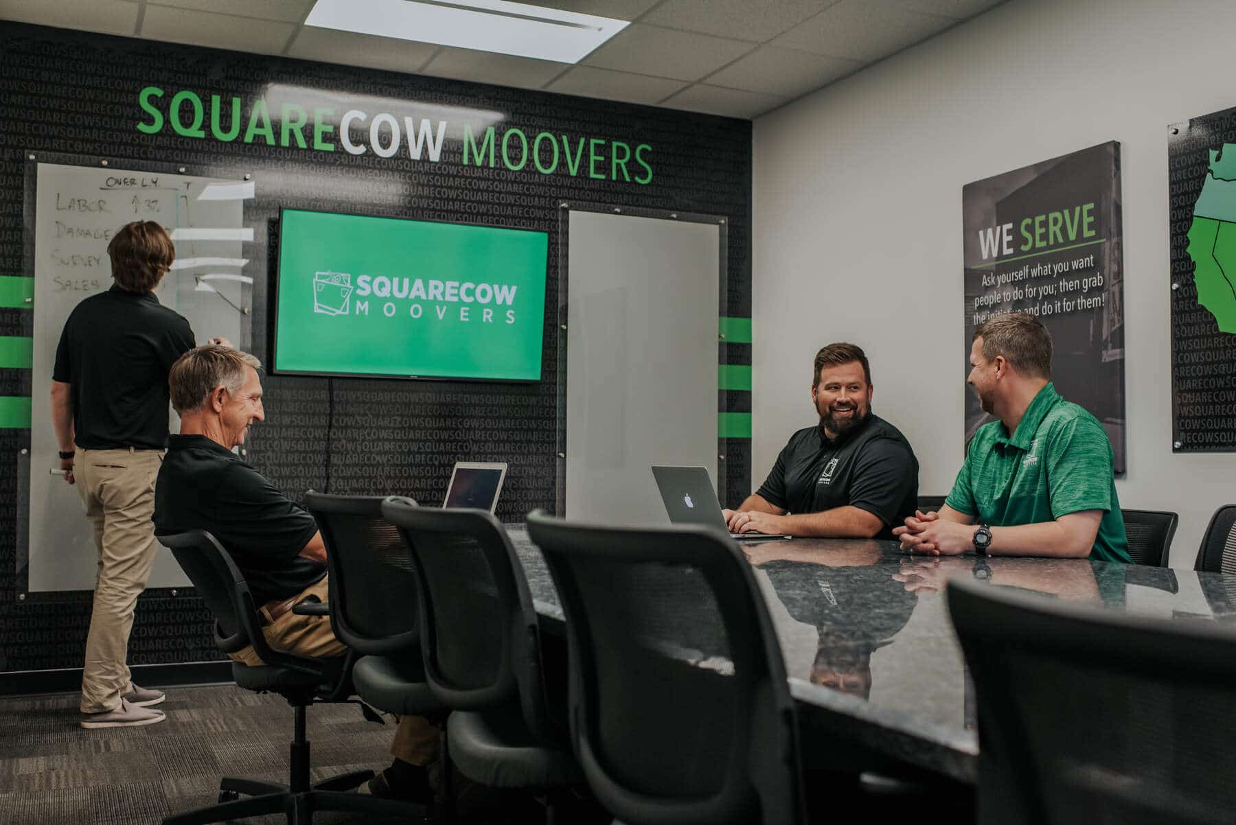 Square Cow Movers team collaborating during a meeting in a conference room