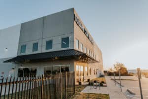Square Cow Movers warehouse and office building at sunrise