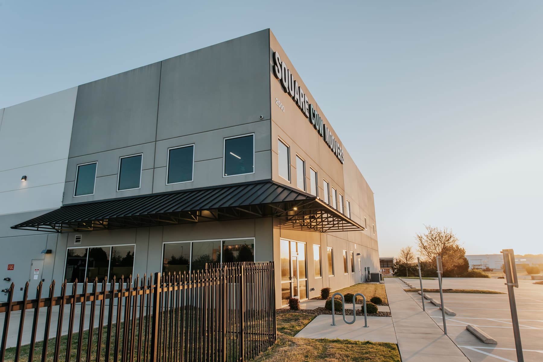 Square Cow Movers warehouse and office building at sunrise