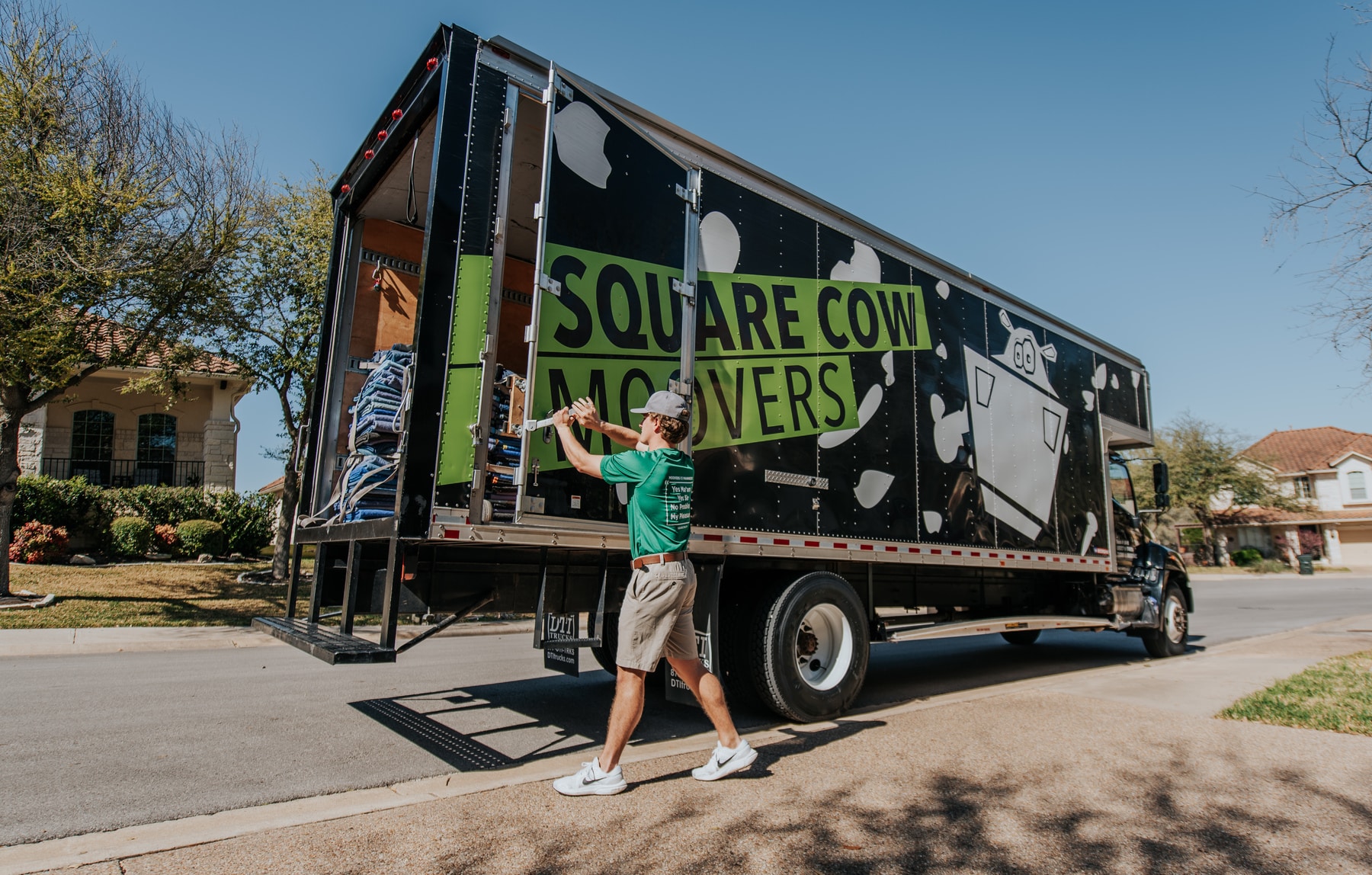 Square Cow mover closing the back of a moving truck