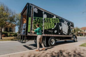 Square Cow mover closing the back of a moving truck